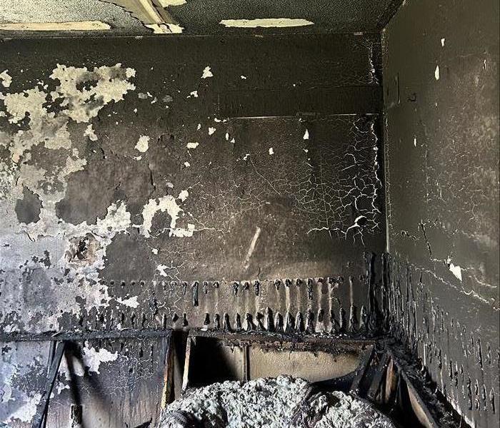 Charred Walls and Bedroom Furniture after Fire 